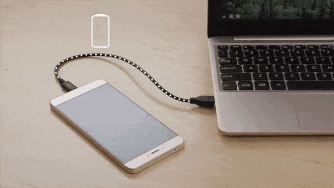 Smartphone en charge connecté à un ordinateur portable