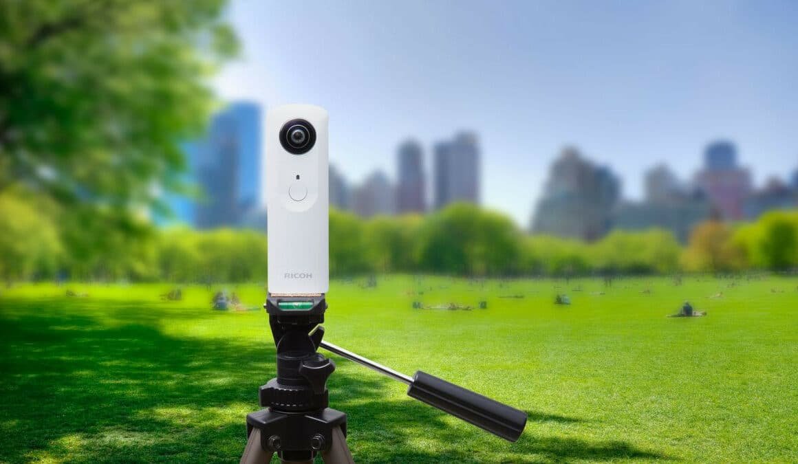 Caméra 360° sur trépied dans un parc avec skyline floue