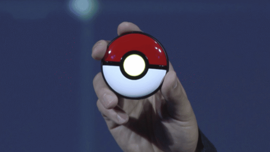 Main tenant un appareil en forme de Poké Ball