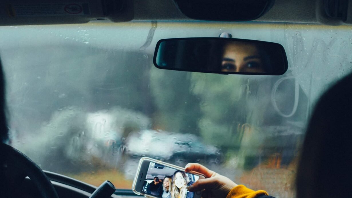 Personne prenant un selfie en voiture par temps pluvieux