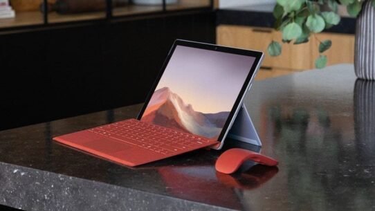 Tablette avec clavier et souris rouge sur une table noire