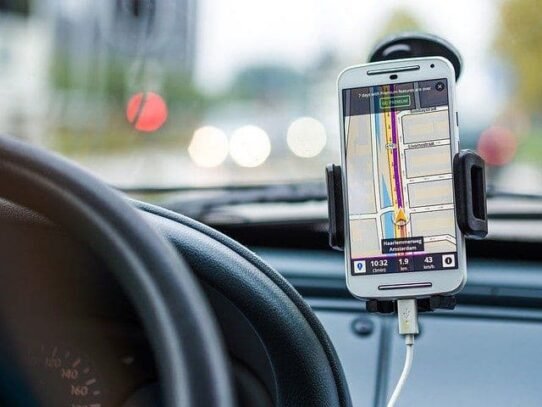 Smartphone affichant une application GPS dans une voiture