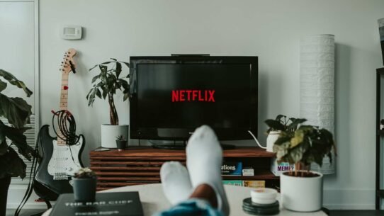 Personne détendue devant une télévision affichant Netflix dans un salon