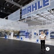 Salon professionnel avec signalétique Mahle et visiteurs