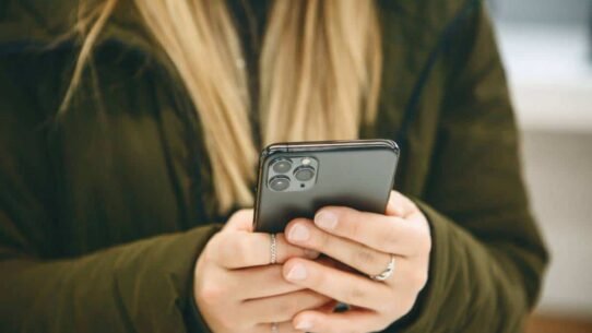 Personne tenant un smartphone moderne dans ses mains