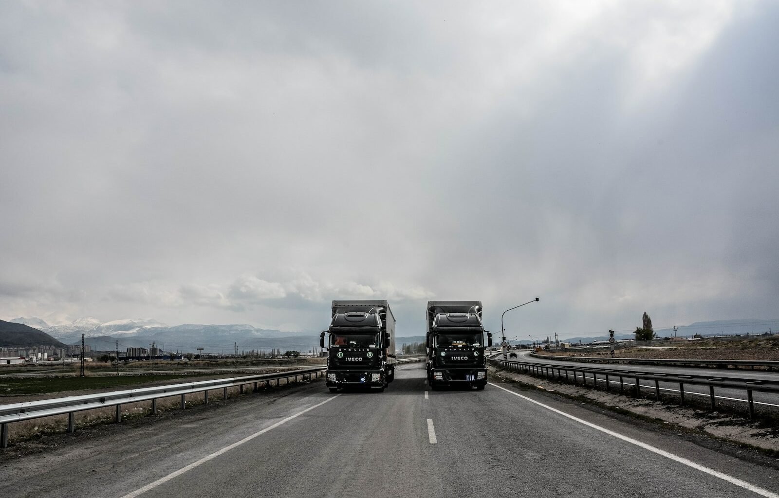 blue and white truck on road during daytime