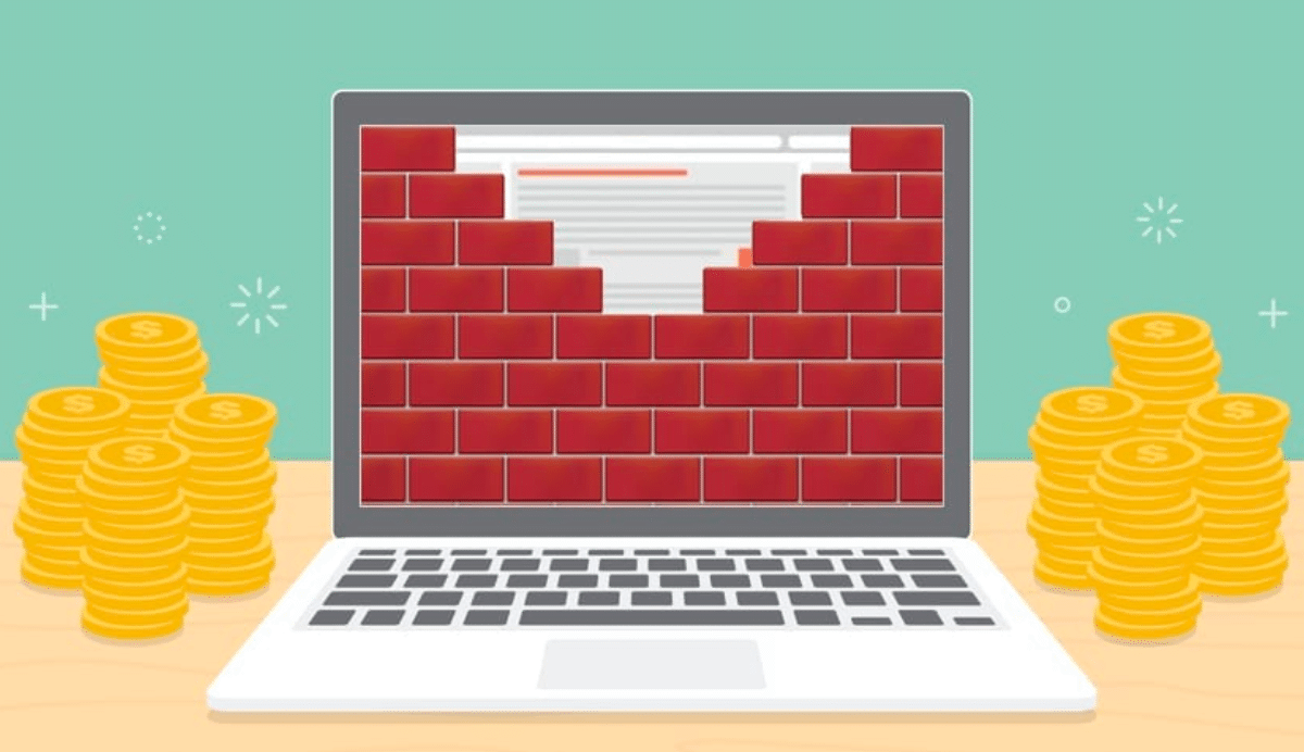 Ordinateur avec mur de briques et piles de pièces d'or