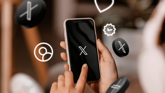 Main tenant un smartphone avec des icônes numériques flottantes