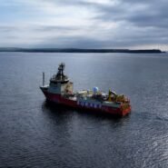 Navire de recherche rouge naviguant sur une mer calme